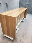 Solid wood console table finished with a clear coat to showcase natural grain and warmth. Solid wood console table with a clear satin finish highlighting natural grain, finished in a professional spray booth.