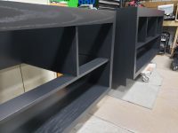 Built-in shelving units finished in a rich dark stain with a smooth, even sheen. Custom built-in shelving finished with a smooth dark wood stain and clear coat by Leone’s Custom Coatings.