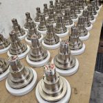 Precision industrial components prepared for high-performance coating at Leone’s Custom Coatings. Precision-machined industrial metal components staged for coating and finishing by Leone’s Custom Coatings in Traverse City, Michigan.